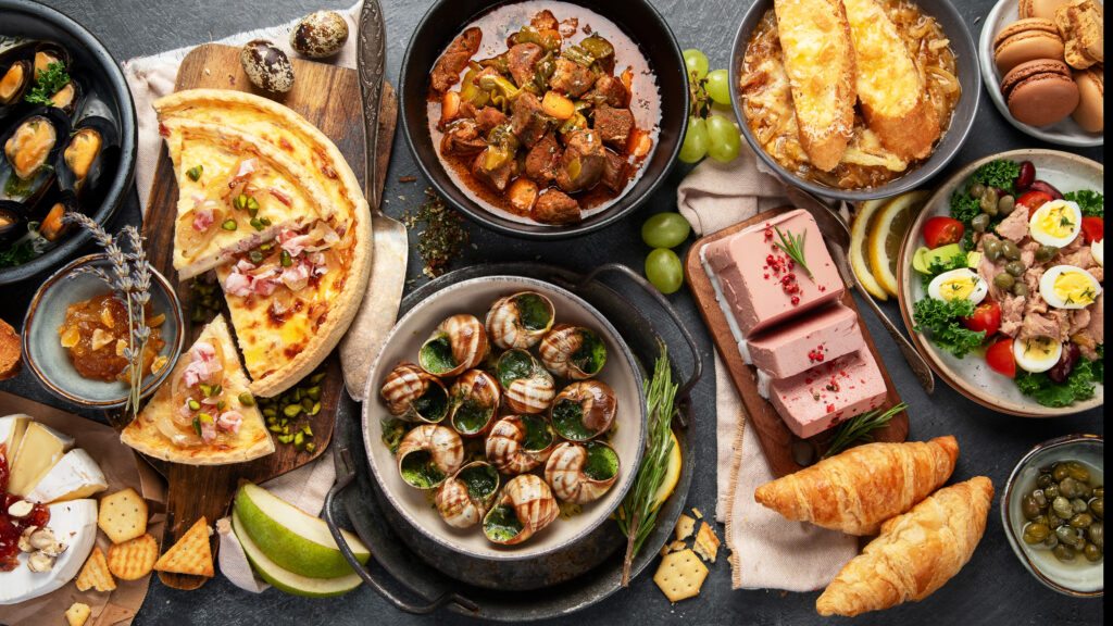 Home traditional french food mussel and meat dishes, ratatouille, snails, croissants, desserts, fresh pastries and cheese.